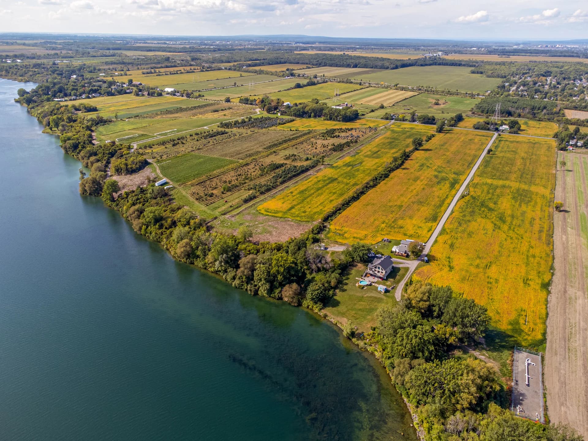 Drone view of fields and properties along a river