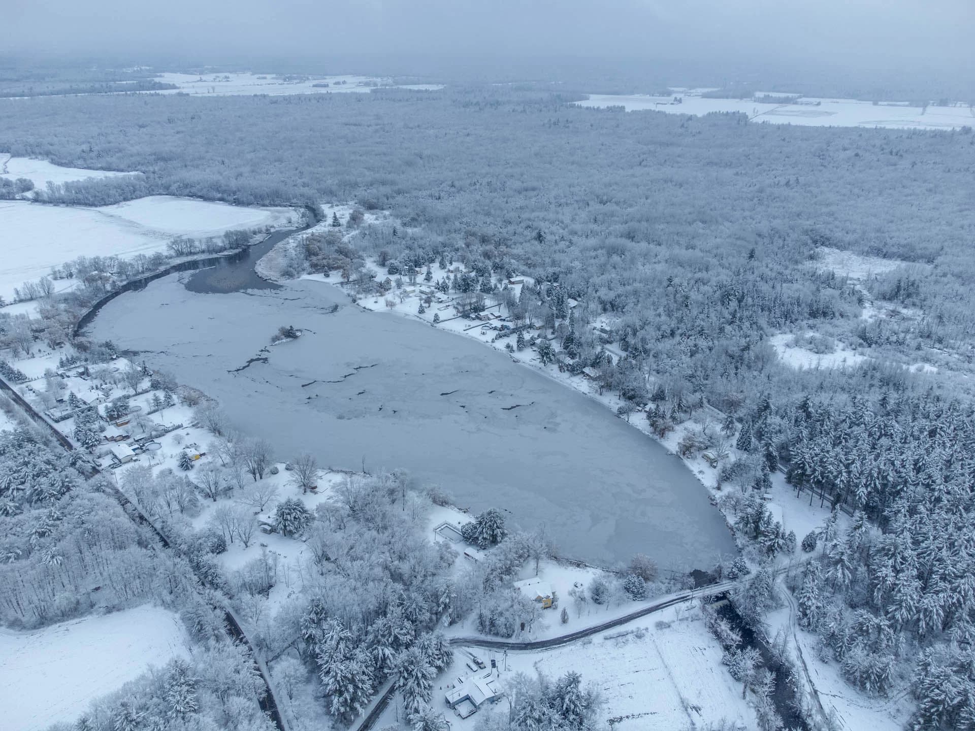 Aerial view of lakes and a snow-covered forest
